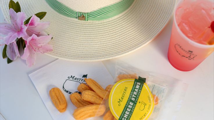 A Masters spread — cheese straws, pink lemonade, and a sun hat